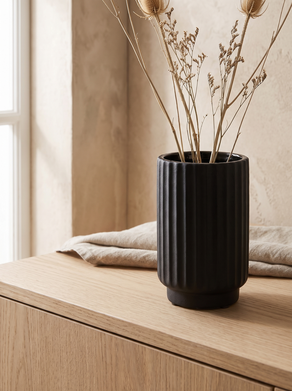 Fluted Black Ceramic Vase in a home setting — light across the ridges